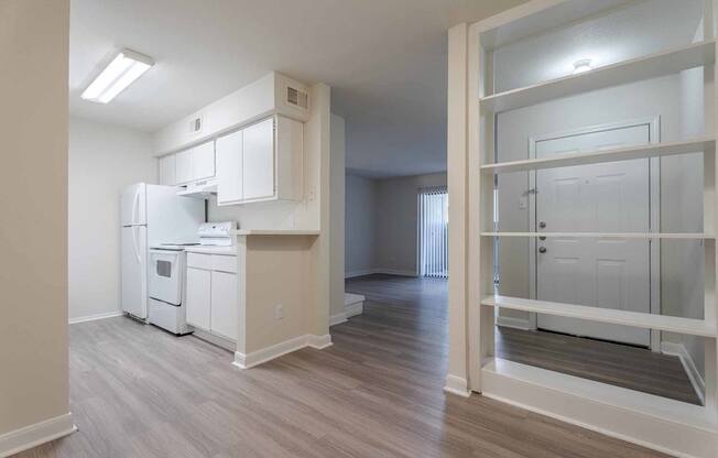 A kitchen with white appliances and a white fridge.