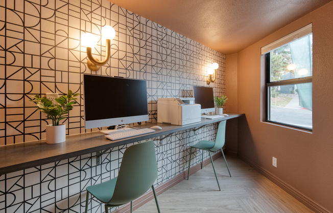 Business center table with computers and chairs in Clubhouse at Treehouse in Albuquerque, New Mexico