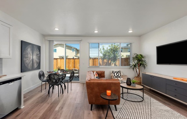 a living room with a couch and a table and a television