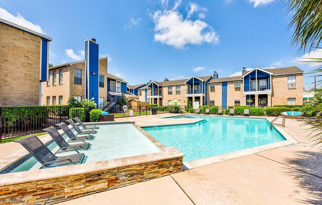 a large brick building with a pool in front of a house