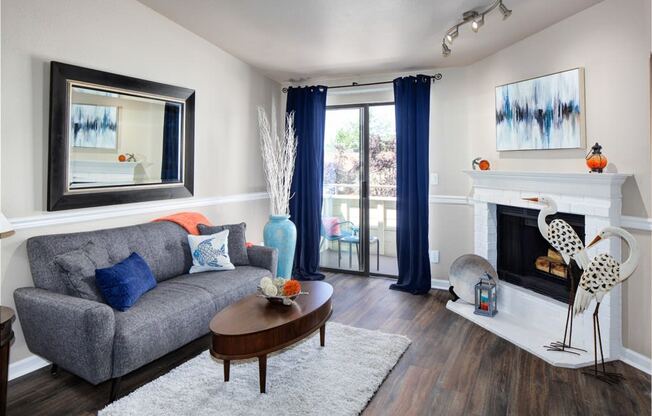 a living room with a fireplace and a couch at 2000 Lake Washington Apartments, Renton, WA