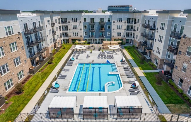 an aerial view of an apartment building with a swimming pool