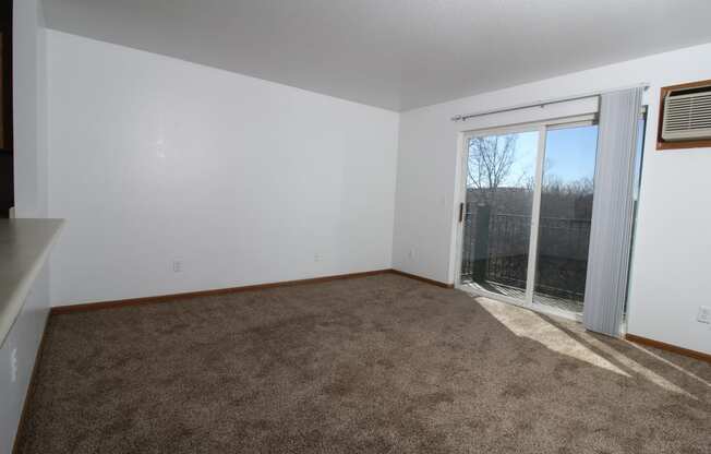 a living room with a door to a balcony