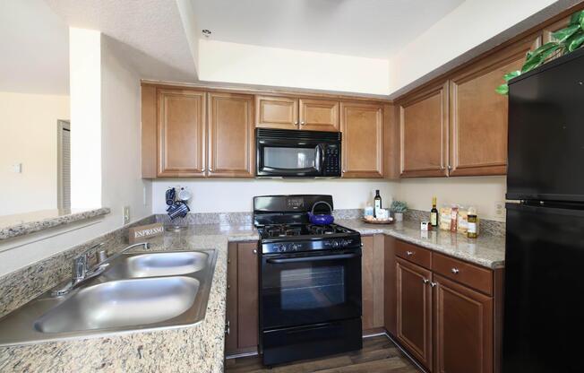 a kitchen with a stove a sink and a microwave