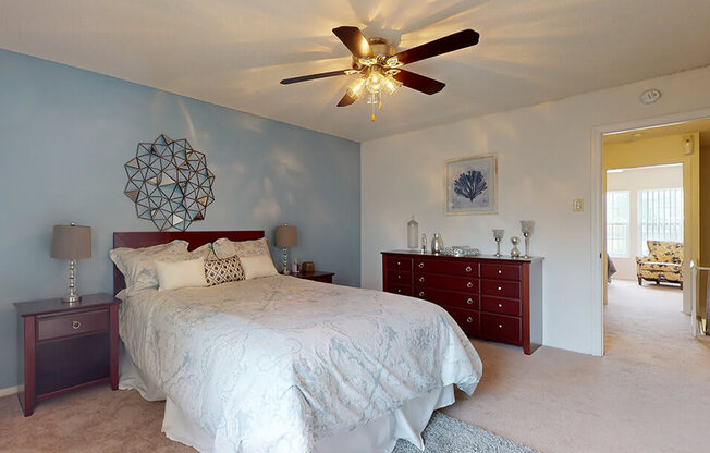 a bedroom with a bed and a ceiling fan