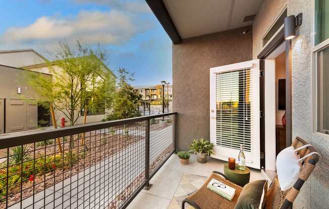 a balcony with a couch and a chair and a fence