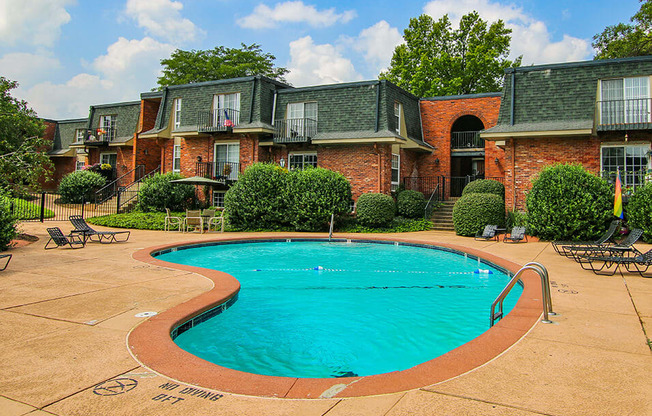 a large swimming pool in front of a house