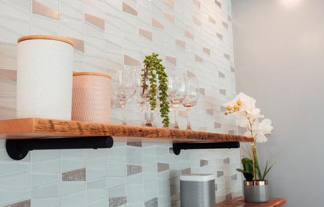 a shelf with wine glasses and flowers on it at Barrington 101, Chicago