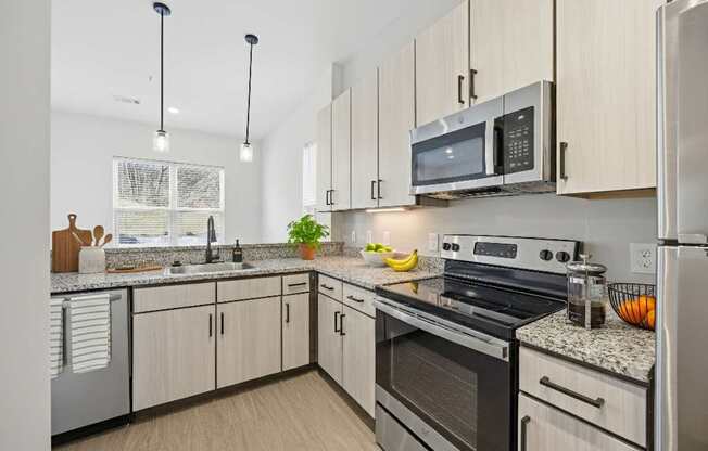 A kitchen with a stove, oven, and refrigerator.