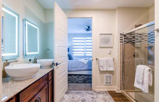 A bathroom with a white sink and a mirror above it.at Carson Street Towers, Kansas