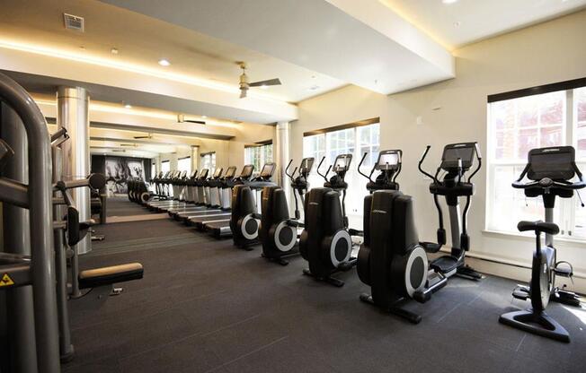 a gym with a large row of exercise bikes