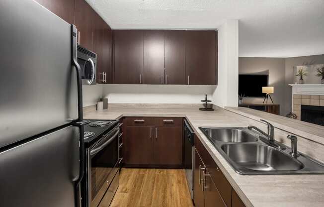 Kitchen with stainless steel appliances and wood flooring at University Ridge Apartments, Durham, NC, 27707