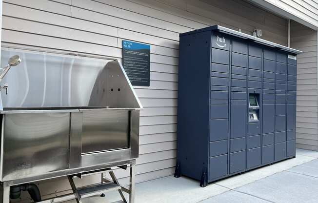 a large metal container and a stainless steel container next to a building