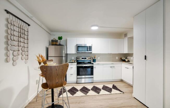 a kitchen with white cabinets and stainless steel appliances at Presidio Palms Apartments, Tucson, AZ, 85701