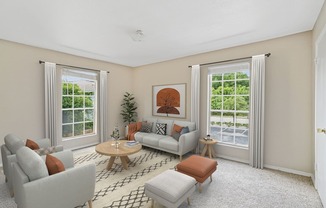 A living room with a grey couch, a brown ottoman, a wooden coffee table, and a potted plant.