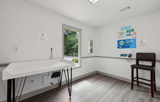 A laundry room with a folding counter at Gwinnett Square Apartments in Duluth, GA