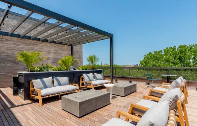 a rooftop deck with couches and a fire pit at TREO Apartments, Cleveland, 44116