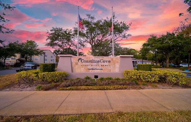 The entrance to Coastline Cove Estates is framed by a beautiful sunset.