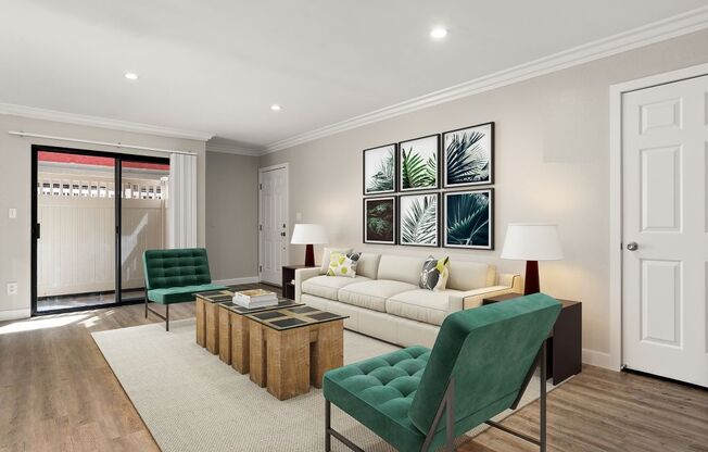 A living room with a green chair and a white couch.
