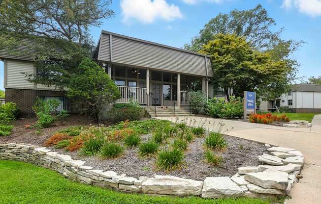 A small building with a landscaped garden in front.