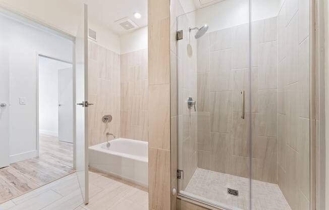 a large white bathroom with a shower and a tub