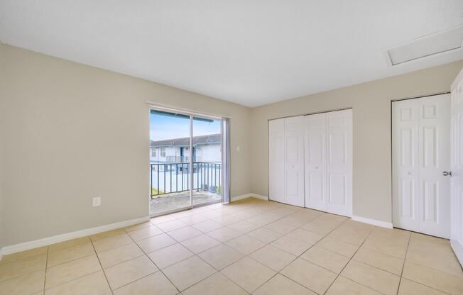 the living room has a sliding glass door to the balcony