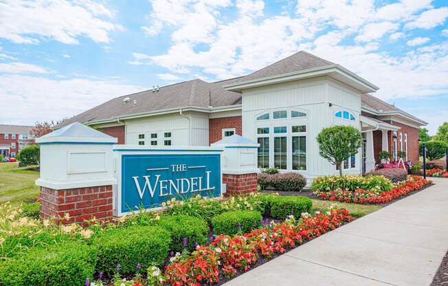 the residences at the wendel building entrance with flowers and plants