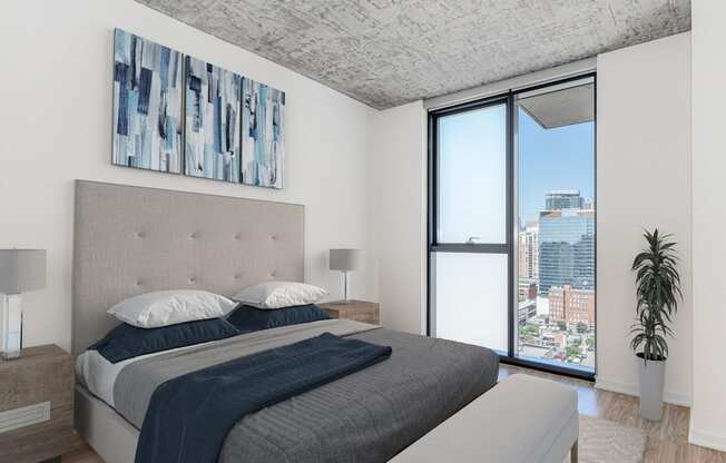 a bedroom with a bed and a large window at One 333, Chicago, Illinois, 60605