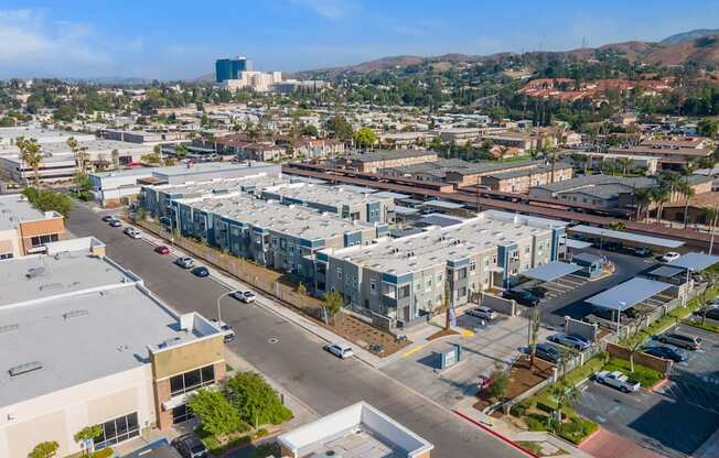 a cityscape of a city with a train track in the middle of it at Loma Villas Apartments, San Bernardino, CA