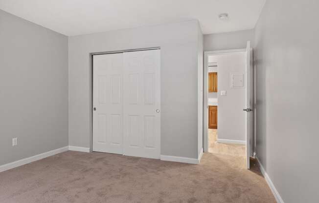 Empty bedroom with closet and door  at the River, Manchester, 03102