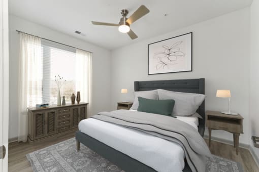a bedroom with a large bed and a ceiling fan at The Waterford At Rocketts Landing Apartments, PRG Real Estate, Richmond, Virginia