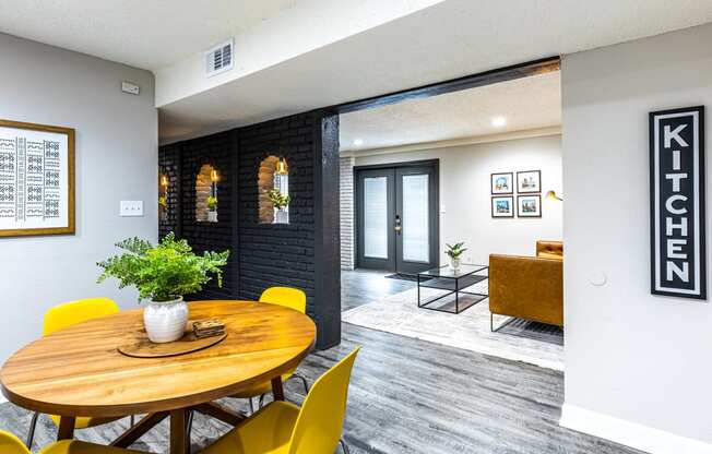 a dining room with a wooden table and yellow chairs