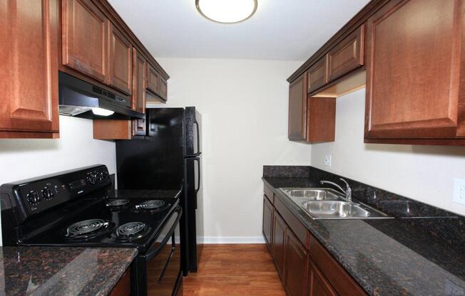 a modern kitchen with stainless steel appliances and wooden cabinets