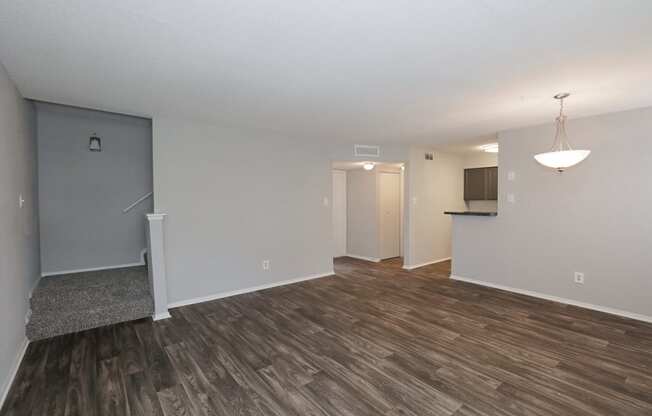 a living room with hardwood floors and grey walls