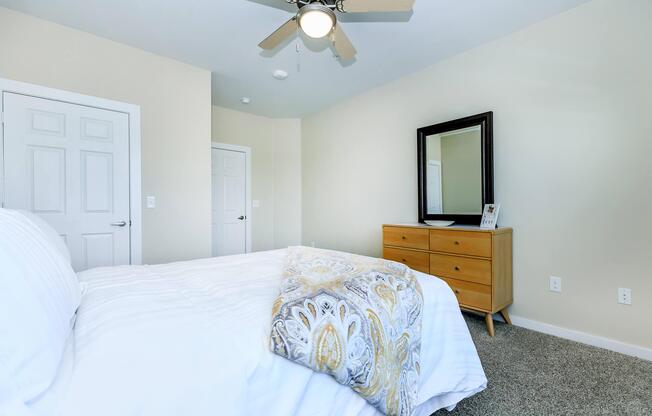 a bedroom with a bed and desk in a small room