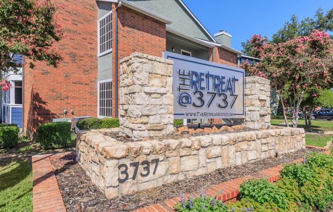 a sign in front of a brick building