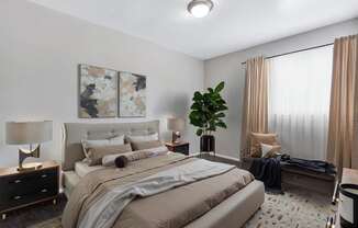 A bedroom with a large bed and a painting on the wall.