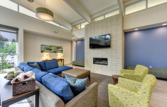 Community Clubhouse Lounge with Fireplace, Lime Sofa Chairs, Mounted Flat Screen Television and Table Lamps