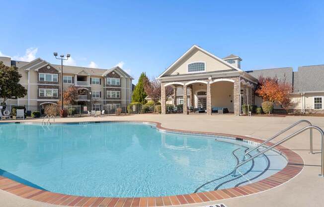 A swimming pool in front of a building with a sign that says 25 FT 09M.