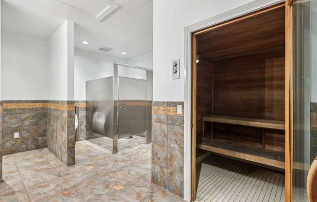 A bathroom with a walk-in shower and a wooden door.