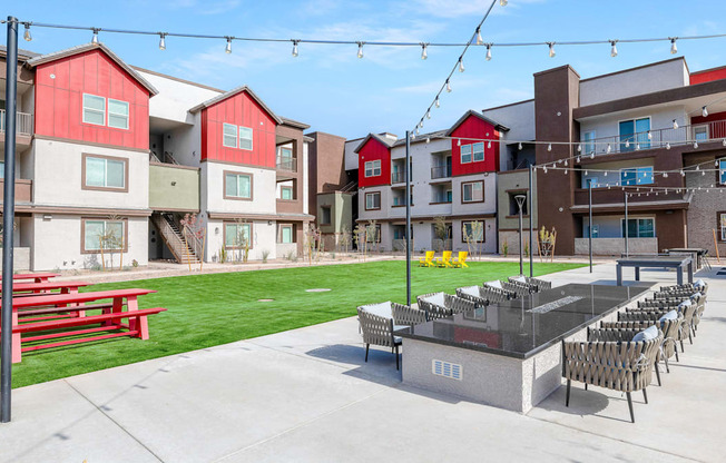 A red and white building with a patio and chairs.