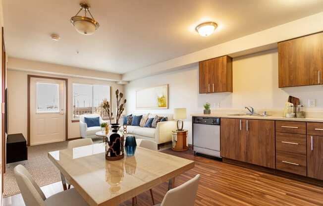 a living room with a kitchen and a dining table