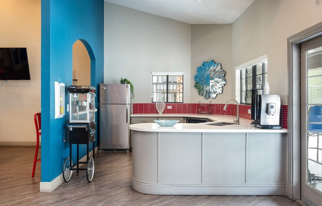 a kitchen with a counter top and a refrigerator and a sink