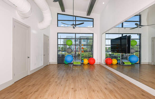 a large room with hardwood floors and large windows