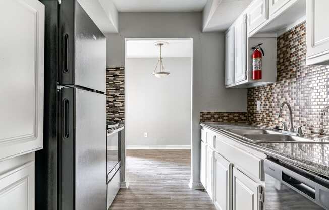 the kitchen of a new home with white cabinets and stainless steel appliances