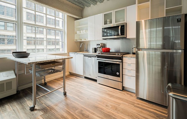 a kitchen with stainless steel appliances and a table