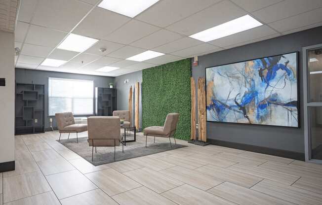 an image of a lobby with chairs and a green wall