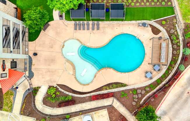 an aerial view of a swimming pool with a blue pool