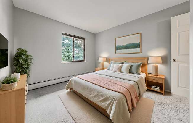 A bedroom with a large bed and a window.