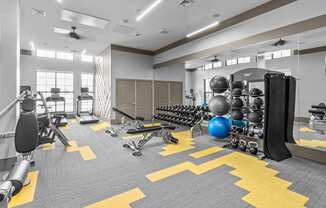 a gym with weights and cardio equipment and a punching bag at Alton Jefferson Park, Denver, CO